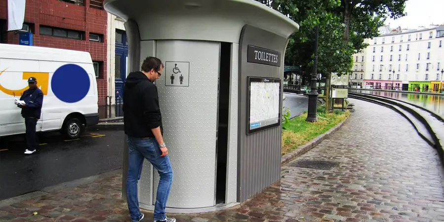 A man going to roadside public toilet