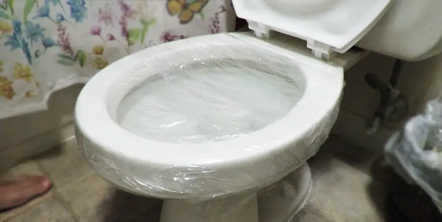 Layer of Plastic Wrap Over the Toilet Bowls