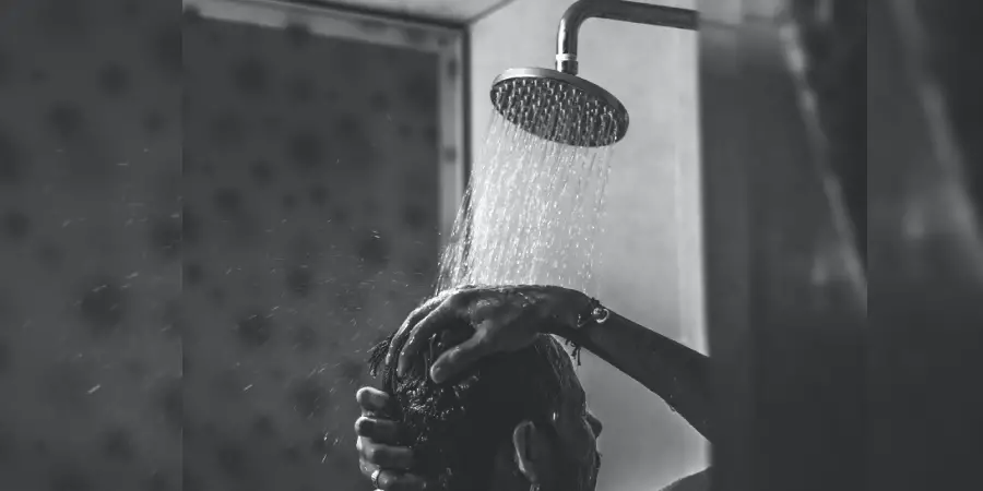 A man take shower in bathroom